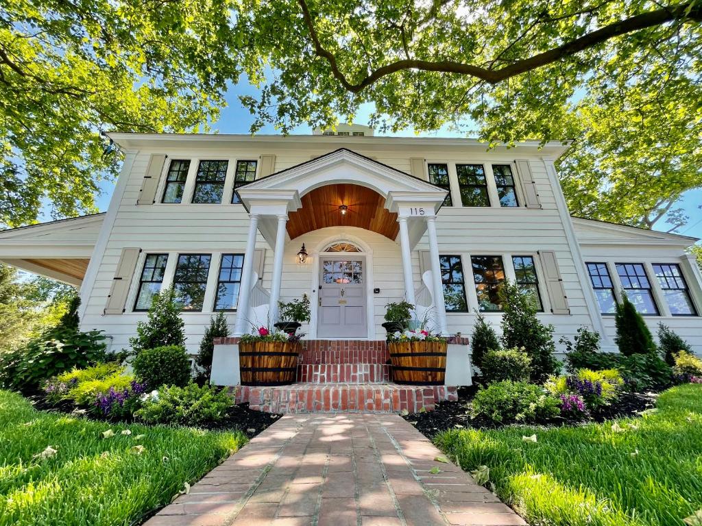 a large white house with a large window in front of it at Buttonwood Boutique Hotel in West Cape May