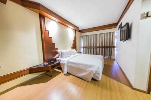 Cama o camas de una habitación en Phenícia Bittar Hotel