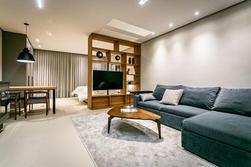 a living room with a couch and a table at Apartamento moderno em condomínio com infraestrutura de clube CA14I in Florianópolis