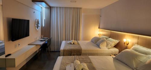 Cama o camas de una habitación en Flat Maravilhoso na praia - Ilusion Hotel
