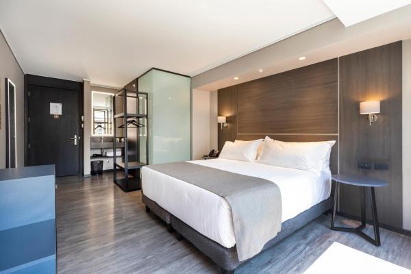 Cama o camas de una habitación en UGO Hotel