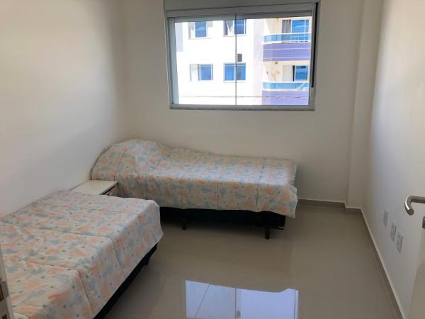 a room with two beds and a window at Apartamento ingleses in Florianópolis
